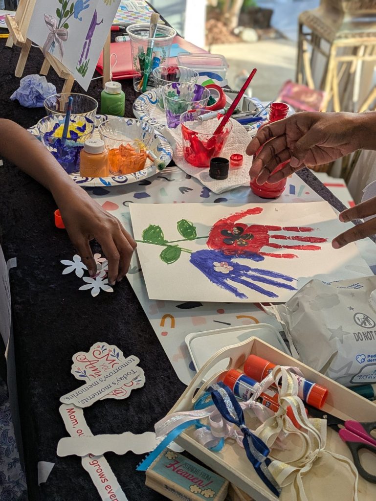 Hands painting a personalized art project at a creative workshop